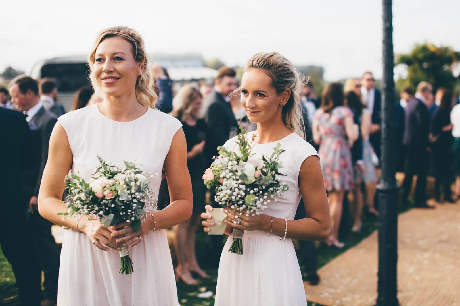 Bridesmaids with cream and pink bouquets at Bridge House Barn Leicestershire